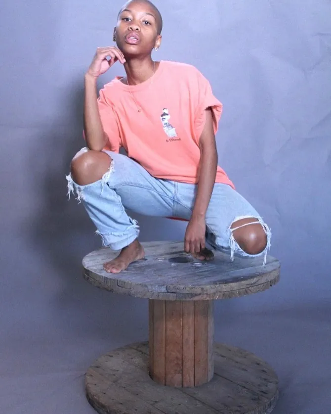 Woman wearing a coral St O'Donnell branded t-shirt